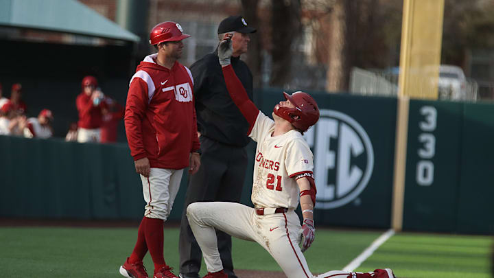 Oklahoma DH Drew Dickerson celebrates a triple at third base.