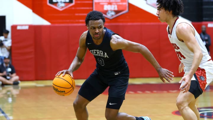 Bronny James, left, drives against Jared McCain during a 2023 California high school basketball game between Sierra Canyon and Corona Centennial.