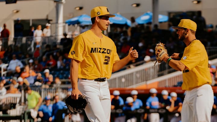 Mizzou starter Kaden Jacobi fist bumps shortstop Keegan Knutson as he walks off the mound against the Florida Gators. 