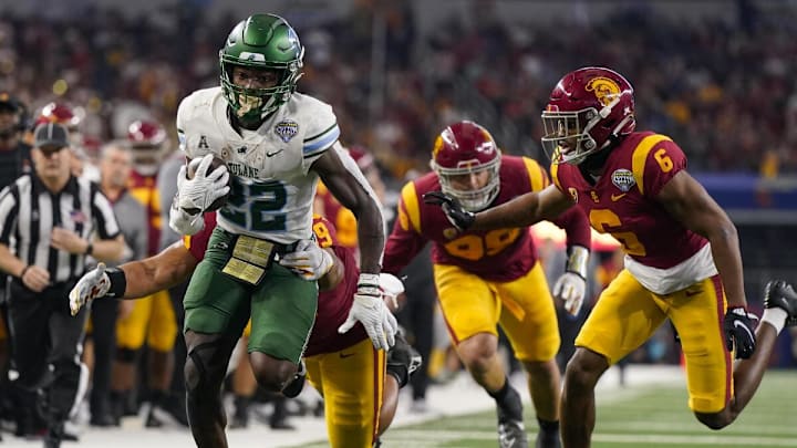 Green Wave RB Tyjae Spears running away from defenders in a win against the Trojans in a Cotton Bowl Victory. Green Wave RB Tyjae Spears running away from defenders in a win against the Trojans in a Cotton Bowl Victory.