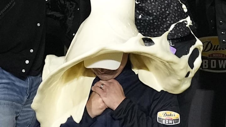 Dec 27, 2023; Charlotte, NC, USA; West Virginia Mountaineers head coach Neal Brown gets covered in mayonnaise after winning the Duke   s Mayo Bowl at Bank of America Stadium. Mandatory Credit: Bob Donnan-Imagn Images