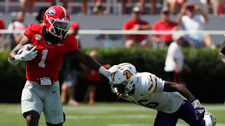 Georgia running back Trevor Etienne (1) stiff-arms Tennessee Tech defensive back Omari Philyaw (16) during the first half of a NCAA college football game in Athens, Ga., on Saturday, Sept. 7, 2024.