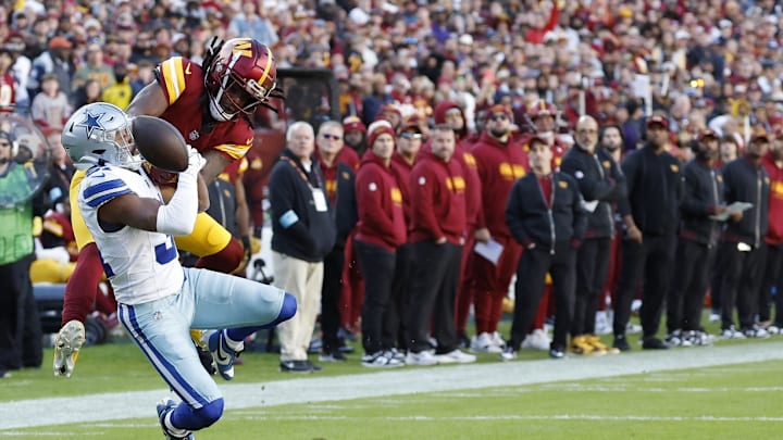 Nov 24, 2024; Landover, Maryland, USA; Washington Commanders wide receiver Noah Brown (85) attempts to Catcha pass as Dallas Cowboys cornerback Josh Butler (31) defends during the second quarter at Northwest Stadium. 