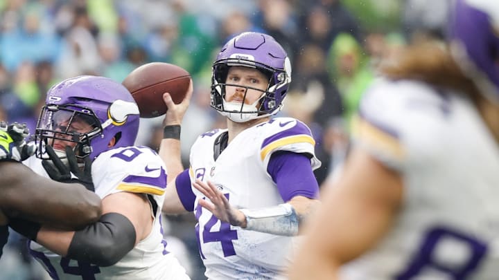 Dec 22, 2024; Seattle, Washington, USA; Minnesota Vikings quarterback Sam Darnold (14) passes against the Seattle Seahawks during the first quarter at Lumen Field. 