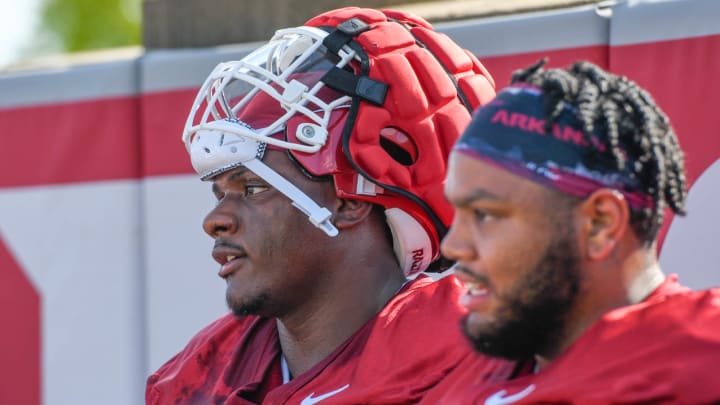 Arkansas Razorbacks defensive lineman Eric Gregory (with helmet) beside Cam Ball at the first practice July 31, 2024, on the outdoor practice field in Fayetteville, Ark. Arkansas Razorbacks defensive lineman Eric Gregory (with helmet) beside Cam Ball at the first practice July 31, 2024, on the outdoor practice field in Fayetteville, Ark.