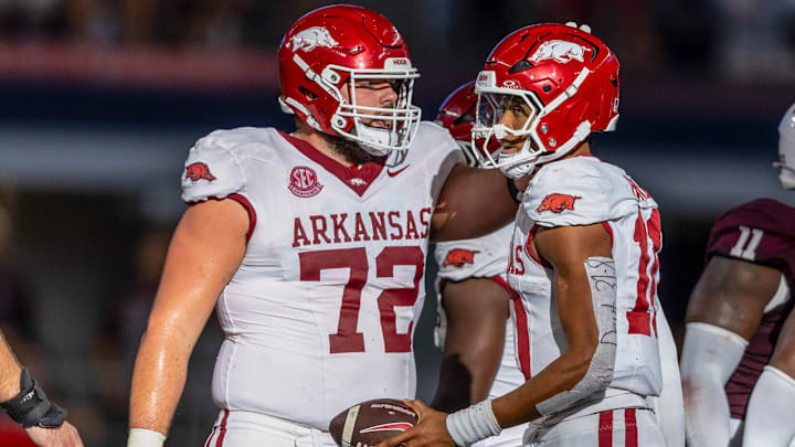 Arkansas Razorbacks offensive lineman with quarterback Taylen Green against the Texas A&M Aggies at AT&T Stadium in Arlington, Texas.