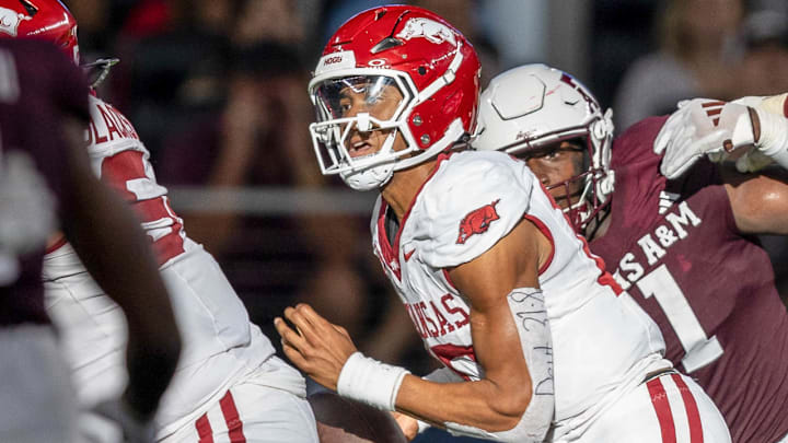 Arkansas Razorbacks quarterback Taylen Green scrambling against the Texas A&M Aggies at AT&T Stadium in Arlington, Texas.