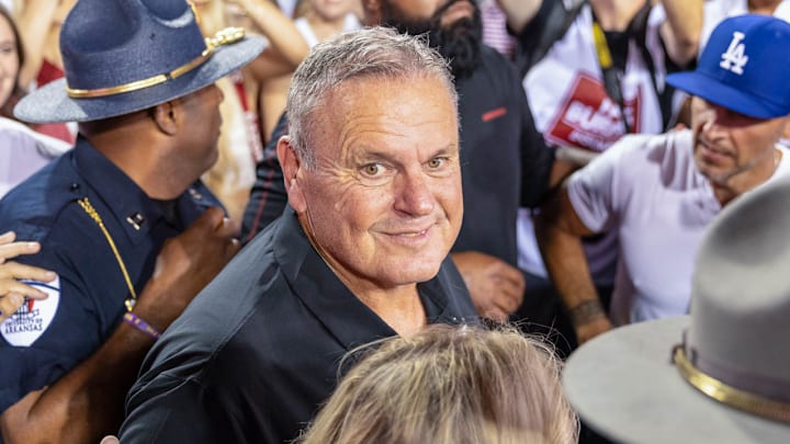 Arkansas Razorbacks coach Sam Pittman celebrating with fans on the field after a 19-14 win over the Tennessee Volunteers at Razorback Stadium in Fayetteville, Ark.