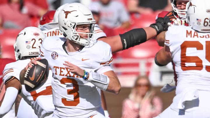 Texas Longhorns quarterback Quinn Ewers sets up to throw a pass against the Arkansas Razorbacks in a 20-10 win at Razorback Stadium in Fayetteville, Ark.