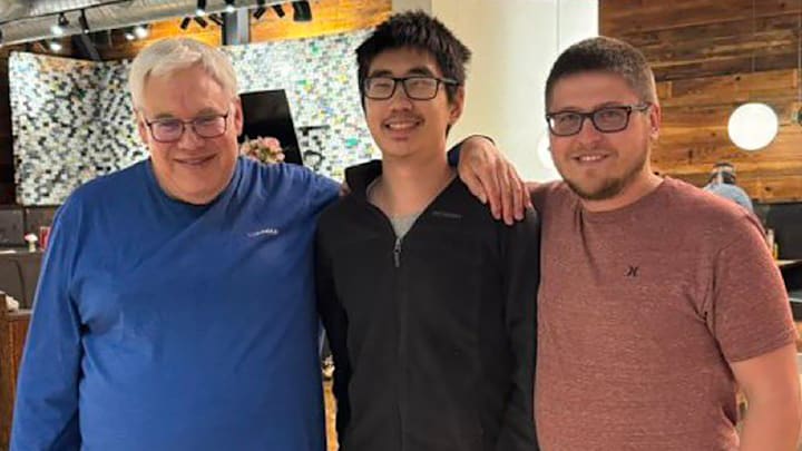 The late Bob Holt of the Arkansas Democrat-Gazette with Hogs on SI's Daniel Shi and Andrew Hutchinson from Best of Arkansas Sports celebrating Shi's 21st birthday.