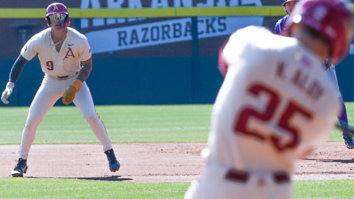 Arkansas shortstop Wehiwa Aloy on the bases against Portland with his brother Kuhio at the plate. The Razorbacks won game 3 of the series 5-3. 