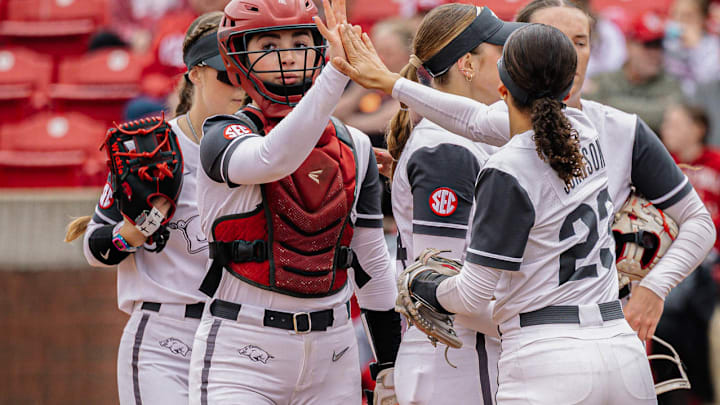 Arkansas Razorbacks celebrate the end of an inning against the Oklahoma Sooners at Bogle Park in Fayetteville, Ark.