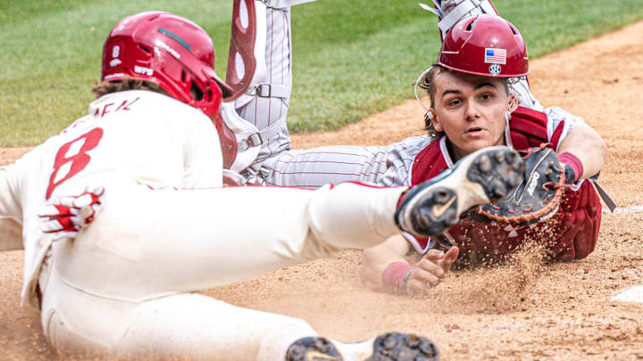 Arkansas Razorbacks Cam Kozeal is tagged out trying to score by South Carolina Gamecocks catcher Gavin Braland in their game at Baum-Walker Stadium in Fayetteville, Ark.