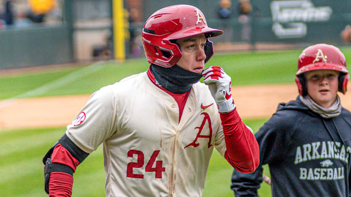 Outfielder Charles Davalan rounds the bases after hitting a three-run homer as part of a seven-RBI day. The Razorbacks won 14-3 against Missouri.
