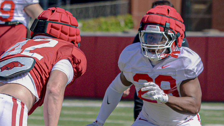 Arkansas Razorbacks linebacker Wyatt Simmons (42) and running back Tyrell Reed facing each other during a recent spring football practices on the outdoor fields in Fayetteville, Ark.