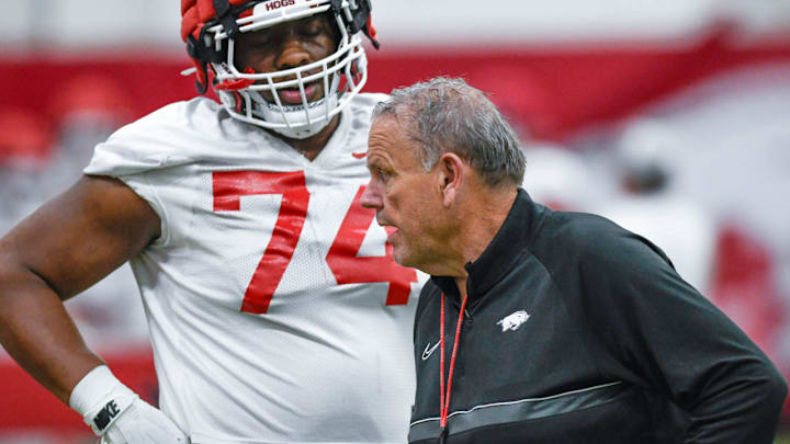 Arkansas Razorbacks coach Sam Pittman talking with offensive lineman Marcus Dumervil on the indoor practice field in Fayetteville, Ark.