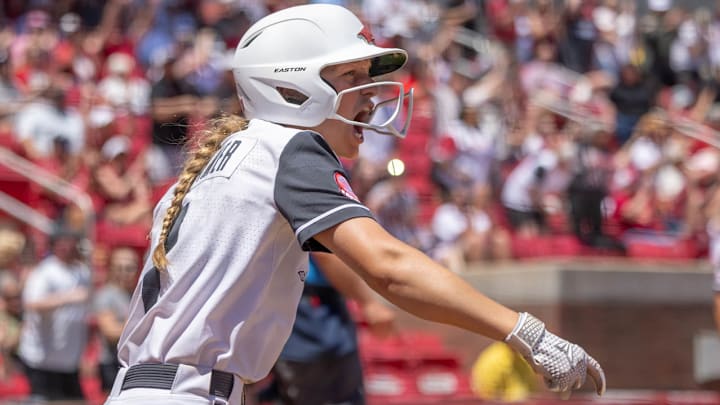 Arkansas Razorbacks left fielder Raigan Kramer celebrates after scoring a run in the seventh inning of a Regional game against Oklahoma State in the NCAA Tournament at Bogle Park in Fayetteville, Ark. Arkansas Razorbacks left fielder Raigan Kramer celebrates after scoring a run in the seventh inning of a Regional game against Oklahoma State in the NCAA Tournament at Bogle Park in Fayetteville, Ark.