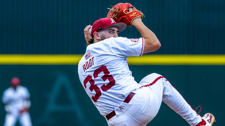 Arkansas Razorbacks pitcher Zach Root winds to throw a pitch against the Tennessee Volunteers in the Super Regional at Baum-Walker Stadium in Fayetteville, Ark. Arkansas Razorbacks pitcher Zach Root winds to throw a pitch against the Tennessee Volunteers in the Super Regional at Baum-Walker Stadium in Fayetteville, Ark.