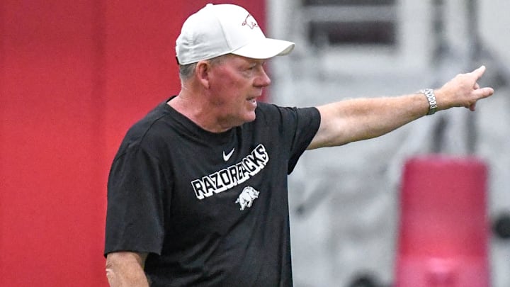 Arkansas Razorbacks offensive coordinator Bobby Petrino directing the offense during practice Monday at the indoor practice field in Fayetteville, Ark.