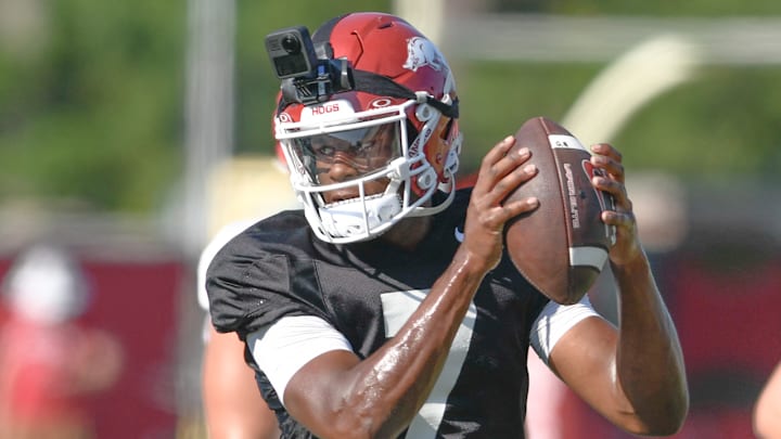 Arkansas Razorbacks quarterback KJ Jackson takes a snap from center in preseason drills on the outdoor practice fields in Fayetteville, Ark.