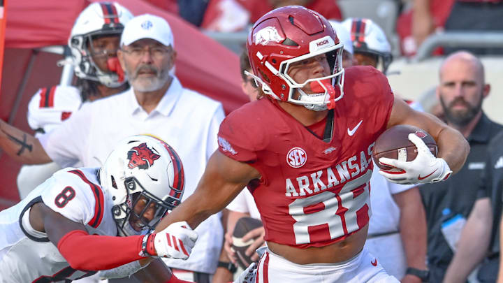 Arkansas Razorbacks tight end Rohan Jones breaks away from an Arkansas State defender in a game at War Memorial Stadium in Little Rock, Ark.