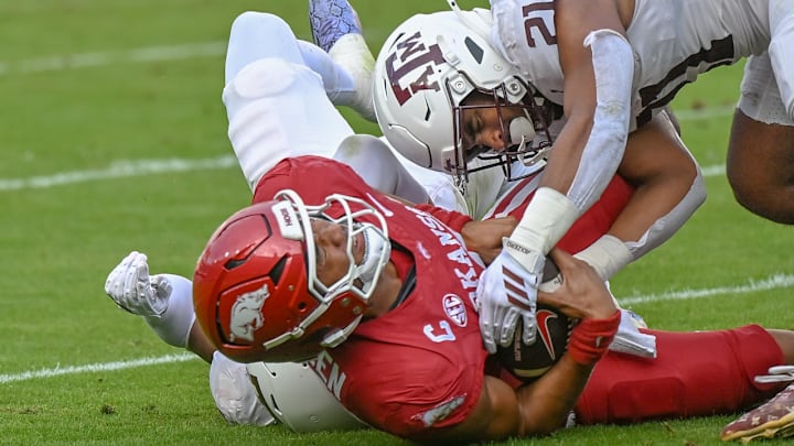 Arkansas Razorbacks quarterback Taylen Green is brought down by Texas A&M defenders in game at Razorback Stadium in Fayetteville, Ark. Arkansas Razorbacks quarterback Taylen Green is brought down by Texas A&M defenders in game at Razorback Stadium in Fayetteville, Ark.