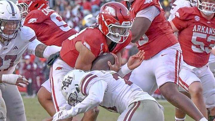 Arkansas Razorbacks quarterback Taylen Green tackled by a Mississippi State defender during a game at Razorback Stadium in Fayetteville, Ark.