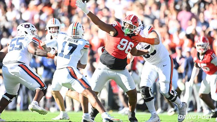 Oct. 17, 2026; Sanford Stadium, Athens, Georgia; Auburn quarterback Byrum Brown (17) eludes Georgia defensive lineman JJ Hanne (96). Oct. 17, 2026; Sanford Stadium, Athens, Georgia; Auburn quarterback Byrum Brown (17) eludes Georgia defensive lineman JJ Hanne (96).
