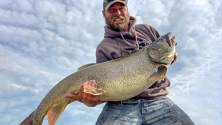 The author hefts his personal best lake trout, caught while downrigger fishing on Lake Superior.