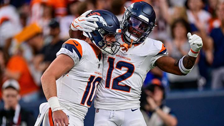 DENVER, CO - AUGUST 21: Denver Broncos quarterback Bo Nix (10) celebrates with running back RJ Harvey (12) after a first-quarter touchdown pass between them during a preseason game against the Green Bay Packers at Empower Field at Mile High on August 21, 2026 in Denver, Colorado.