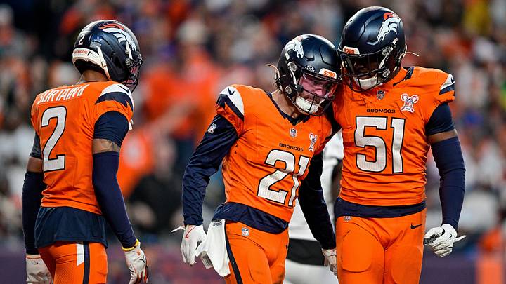 DENVER, CO - DECEMBER 21: Denver Broncos cornerback Riley Moss (21) celebrates a defensive play with cornerback Pat Surtain II (2) and linebacker Que Robinson (51) during a game between the Jacksonville Jaguars and the Denver Broncos at Empower Field at Mile High on December 21, 2025 in Denver, Colorado. 