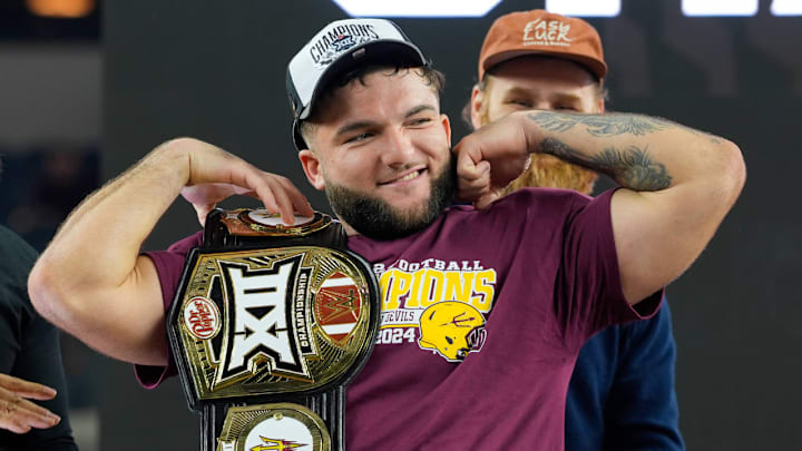 Cam Skattebo poses with the WWE Most Valuable Player Belt