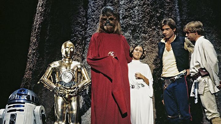 (L to r) R2-D2, Anthony Daniels as C-3PO, Peter Mayhew as Chewbacca, Carrie Fisher as Princess Leia, Harrison Ford as Han Solo, and Mark Hamill as Luke Skywalker in the Star Wars Holiday Special