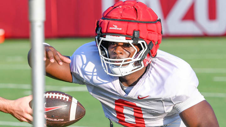 Arkansas Razorbacks running back Braylen Russell taking a handoff in drills Aug. 3, 2024, on the outdoor field in Fayetteville, Ark.