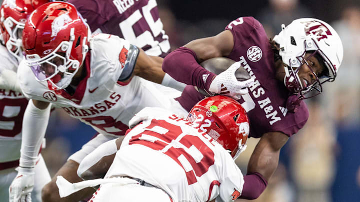 Arkansas Razorbacks defenders Brad Spence (22) and Jayden Johnson (8) against the Texas A&M Aggies at AT&T Stadium in Arlington, Texas.
