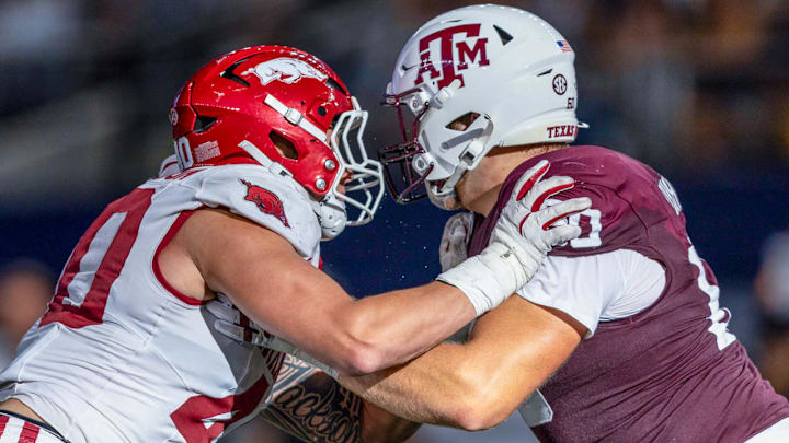 Arkansas Razorbacks defensive lineman Landon Jackson locked up with a Texas A&M offensive player at AT&T Stadium in Arlington, Texas.