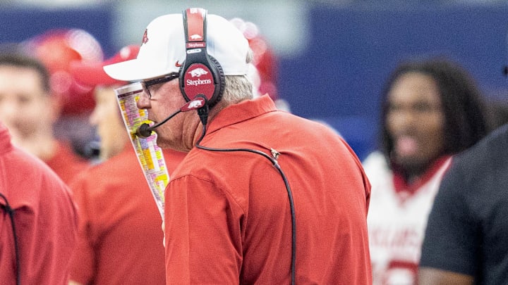 Arkansas Razorbacks offensive coordinator Bobby Petrino on the sidelines calling plays against the Texas A&M Aggies at AT&T Stadium in Arlington, Texas.