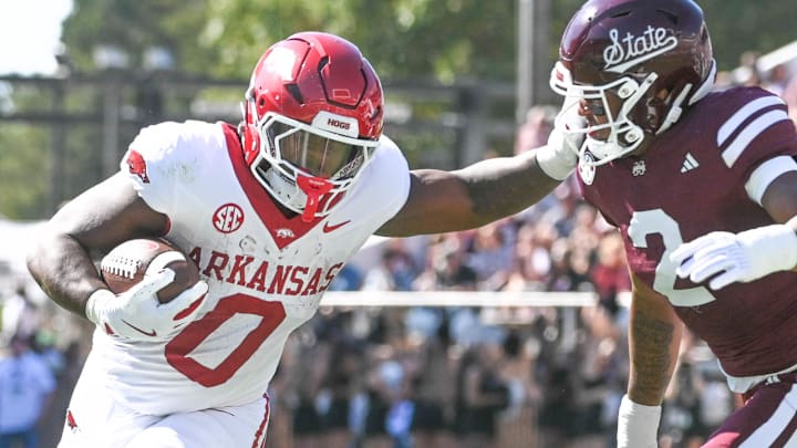 Arkansas Razorbacks running back Braylen Russell (0) stiff-arms Mississippi State Bulldogs safety Isaac Smith (2) during the first quarter at Davis Wade Stadium at Scott Field.