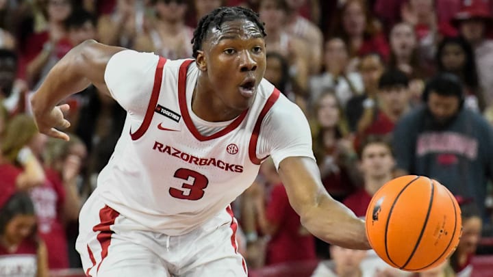 Arkansas Razorbacks guard Adou Thiero bringing the ball upcourt in an exhibition matchup with the Kansas Jayhawks.