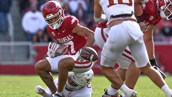 Arkansas Razorbacks wide receiver CJ Brown has the ball stripped from him by Texas Longhorns defensive lineman Alfred Collins.
