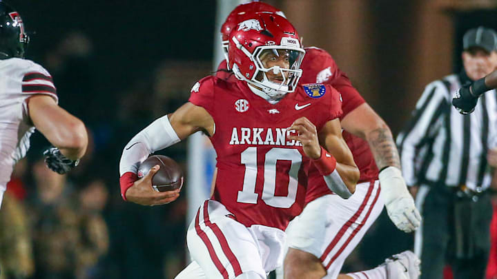 Arkansas Razorbacks quarterback Taylen Green (10) runs the ball for a first down as Texas Tech Red Raiders linebacker Charles Esters III (11) pursues during the second quarter at Simmons Bank Liberty Stadium. Arkansas Razorbacks quarterback Taylen Green (10) runs the ball for a first down as Texas Tech Red Raiders linebacker Charles Esters III (11) pursues during the second quarter at Simmons Bank Liberty Stadium.