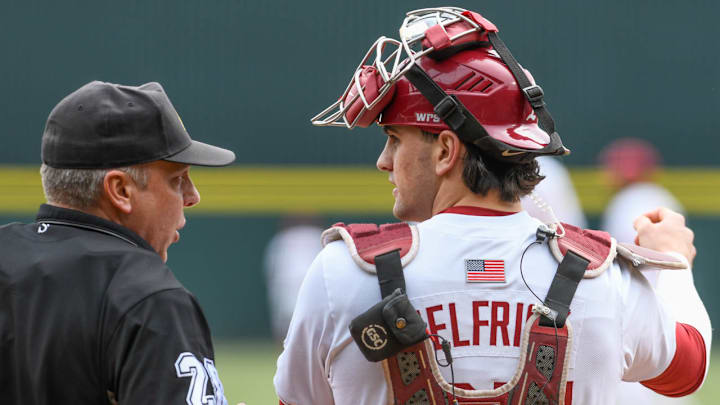 Arkansas Razorbacks catcher Ryder Helfrick talking with home plate umpire in game against the Washington State Cougars Arkansas Razorbacks catcher Ryder Helfrick talking with home plate umpire in game against the Washington State Cougars