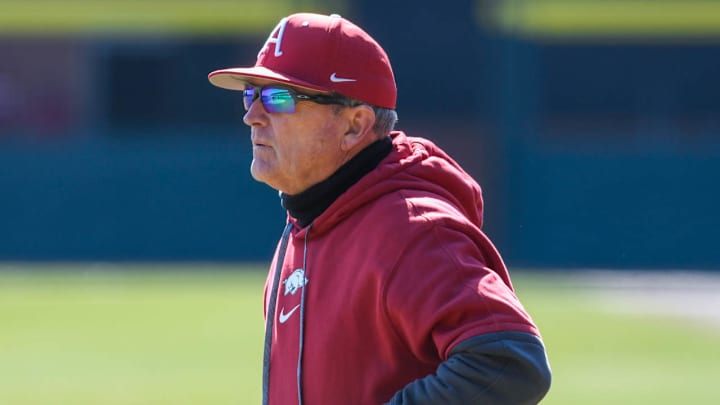 Arkansas Razorbacks coach Dave Van Horn walks the lineup to home plate before the fourth game of the opening series against Washington State.