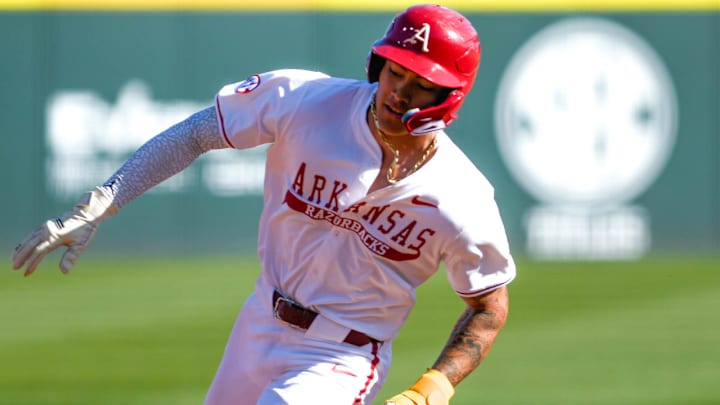 Arkansas Razorbacks shortstop Wehiwa Aloy rounding third base against the Portland Pilots at Baum-Walker Stadium in Fayetteville, Ark.