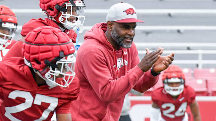 Arkansas Razorbacks secondary coach Marcus Woodson encourages his defensive backs during spring practice drills inside Razorback Stadium in Fayetteville, Ark. Arkansas Razorbacks secondary coach Marcus Woodson encourages his defensive backs during spring practice drills inside Razorback Stadium in Fayetteville, Ark.