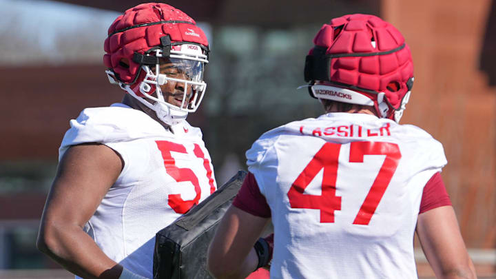 Arkansas Razorbacks offensive tackle Corey Robinson talking with fullback Maddox Lassiter during spring practice drills in Fayetteville, Ark.
