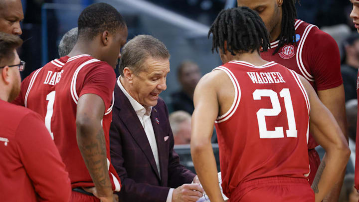 Arkansas Razorbacks coach John Calipari draws up a play during a break in the action against the Texas Tech Red Raiders in the NCAA Sweet 16 Arkansas Razorbacks coach John Calipari draws up a play during a break in the action against the Texas Tech Red Raiders in the NCAA Sweet 16