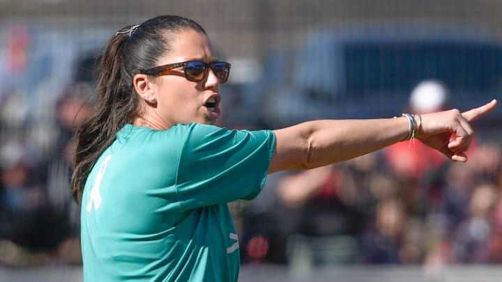 Arkansas Razorbacks coach Courtney Deifel at third base coaching during game against the Kentucky Wildcats at Bogle Park in Fayetteville, Ark.