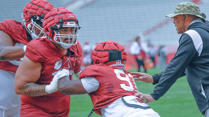 Arkansas Razorbacks defensive lineman Danny Salli going through drills against Kevin Oatis as defensive line coach Deke Adams watches in spring practice inside Razorback Stadium. Arkansas Razorbacks defensive lineman Danny Salli going through drills against Kevin Oatis as defensive line coach Deke Adams watches in spring practice inside Razorback Stadium.
