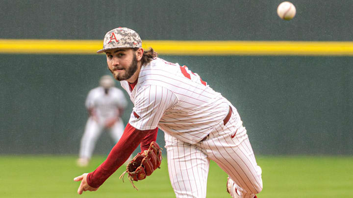 Arkansas Razorbacks pitcher Zach Root delivers a throw to the plate against the Missouri Tigers at Baum-Walker Stadium in Fayetteville, Ark.